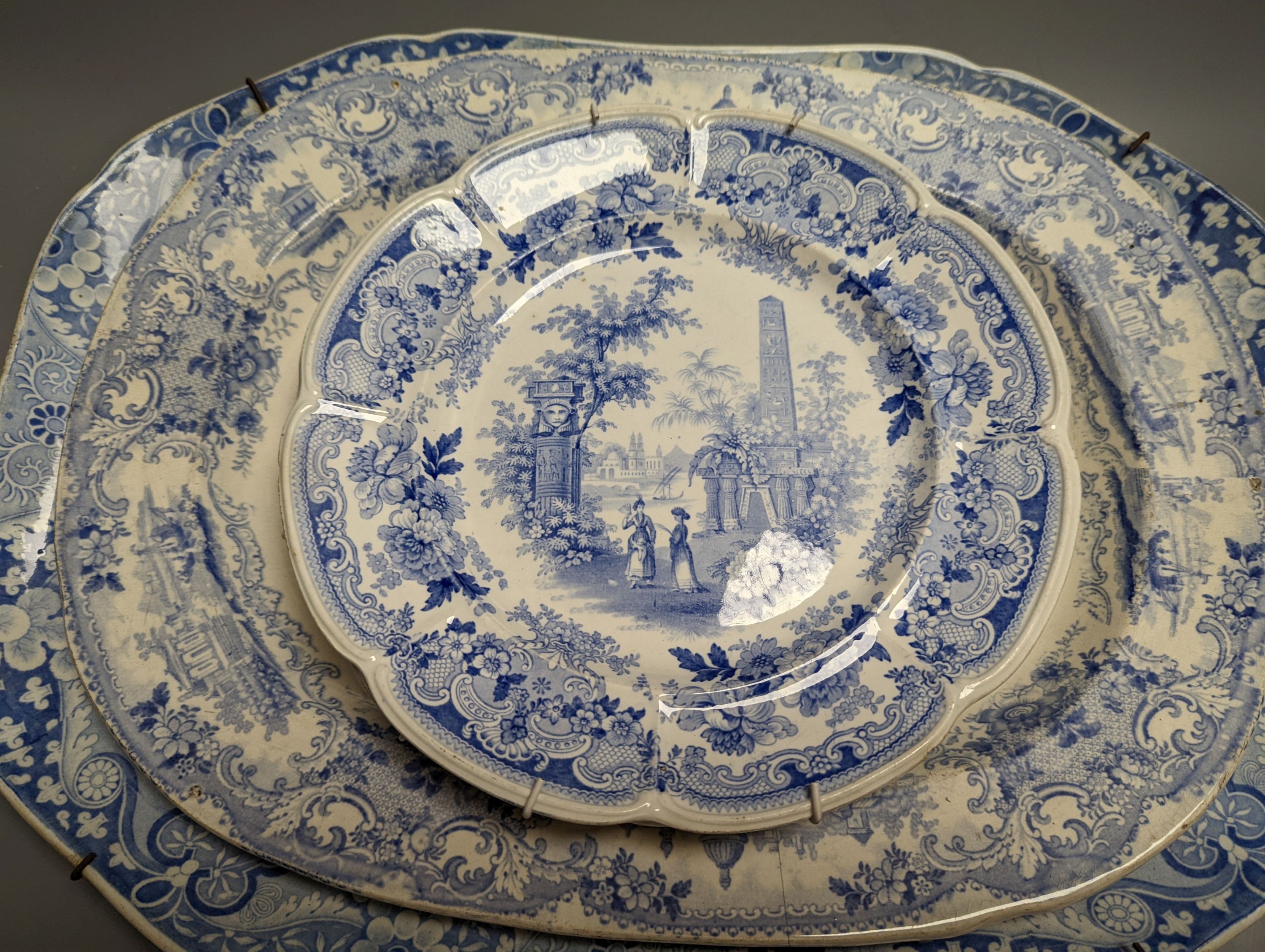 Two 19th century blue and white meat dishes and three similar plates, largest platter 49cms wide